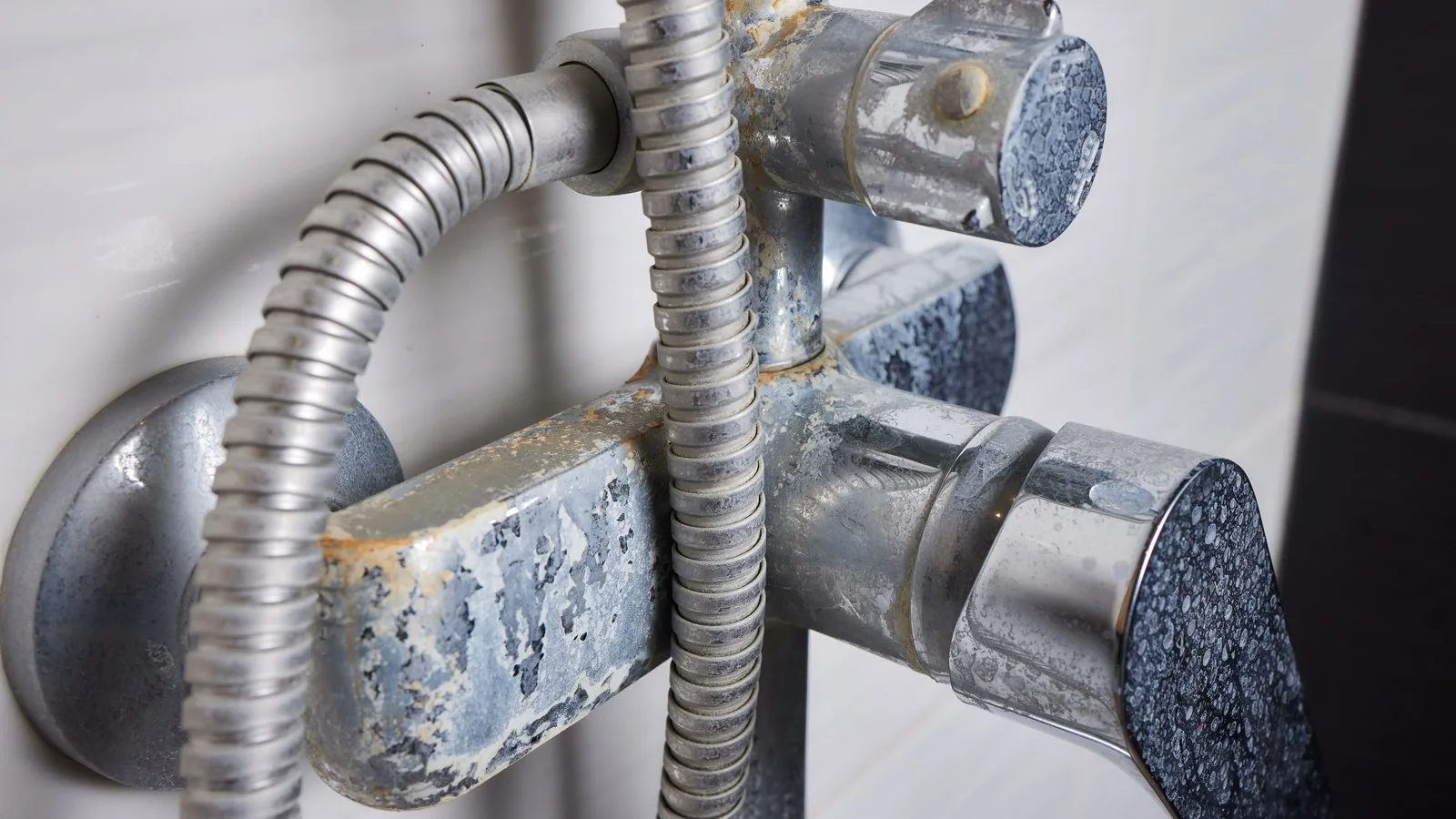 A thin stream of hard water running from an old calcified tap aerator