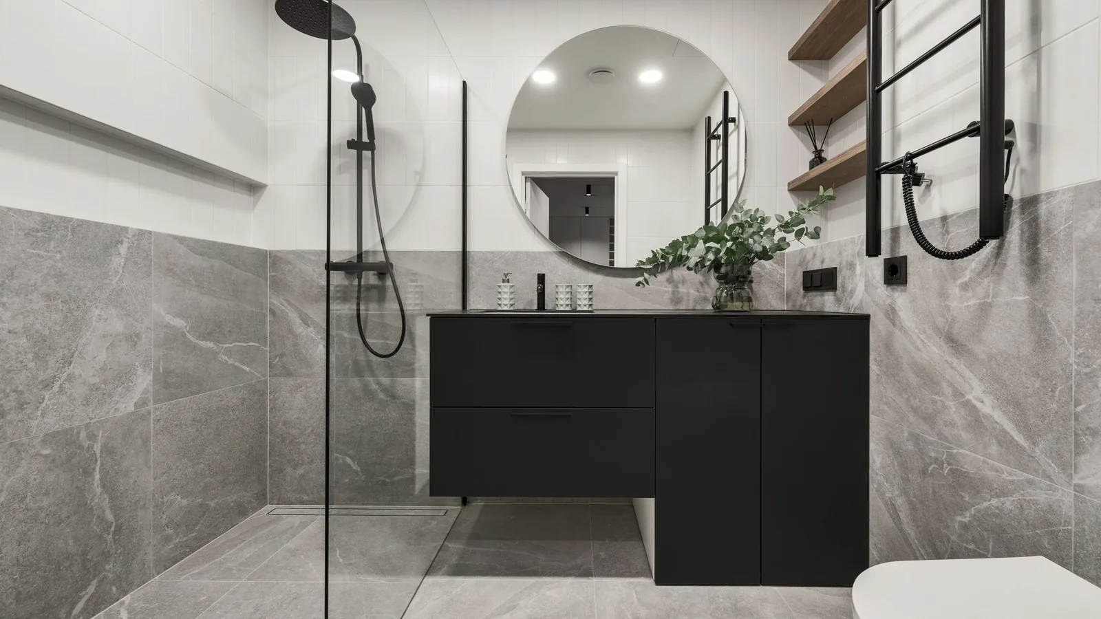Modern minimalist bathroom with grey stone tiles and a walk-in shower